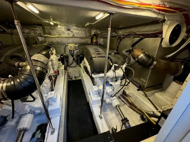 Slide: The Image of Engine room of 2007 Marquis 55 LS yacht, showcasing dual engines and mechanical components. - 25