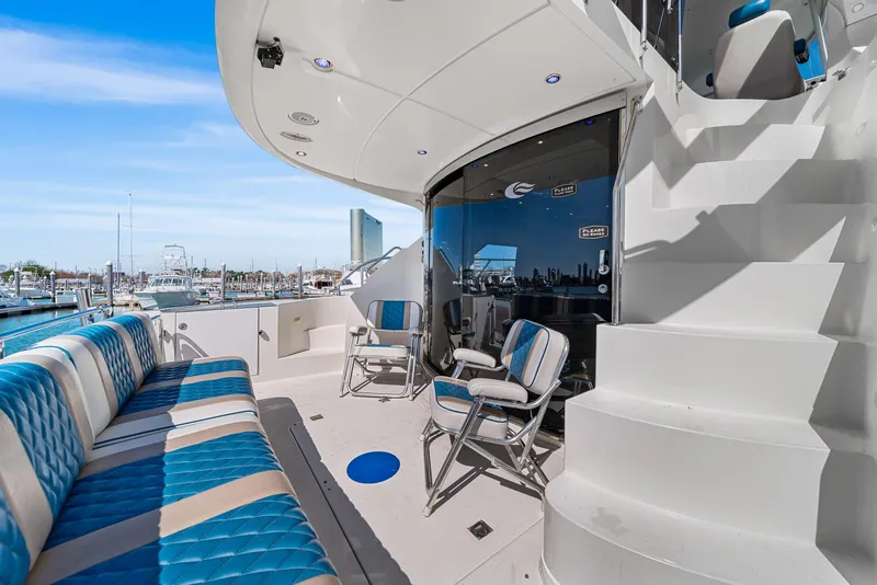 Slide: The Image of 2007 Marquis 55 LS yacht deck with blue seating, marina view, and modern design. - 4
