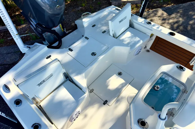 Slide: The Image of Steering console of 2026 Pathfinder 2500 Hybrid boat with chrome details and controls. - 11