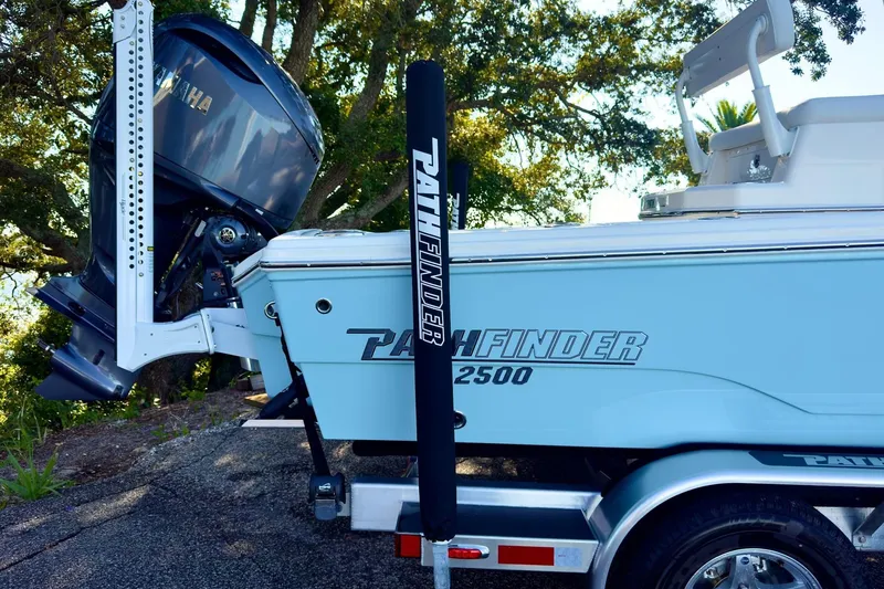 Slide: The Image of 2026 Pathfinder 2500 Hybrid boat interior with white seating and wood accents. - 13
