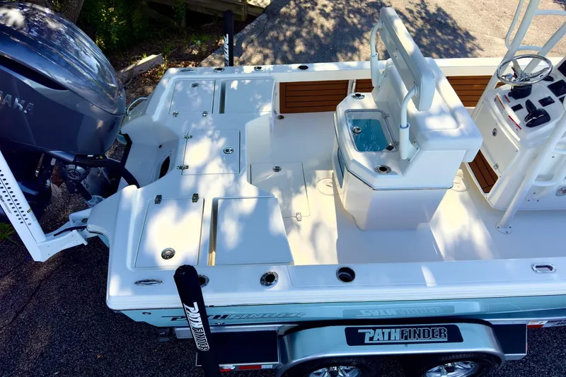 Slide: The Image of 2026 Pathfinder 2500 Hybrid boat with sleek wood paneling and white fixtures. - 14