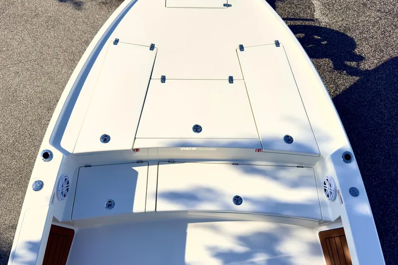 Slide: The Image of 2026 Pathfinder 2500 Hybrid boat interior with steering console and rod holders. - 2