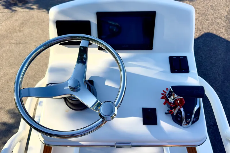 Slide: The Image of 2026 Pathfinder 2500 Hybrid boat deck with storage compartments and speakers. - 9