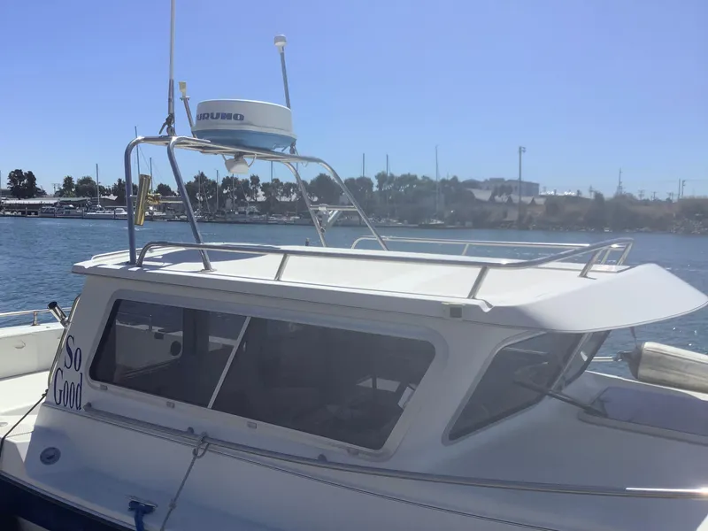 Slide: The Image of 2007 SeaSport Explorer 2400 boat docked in sunny marina. - 2