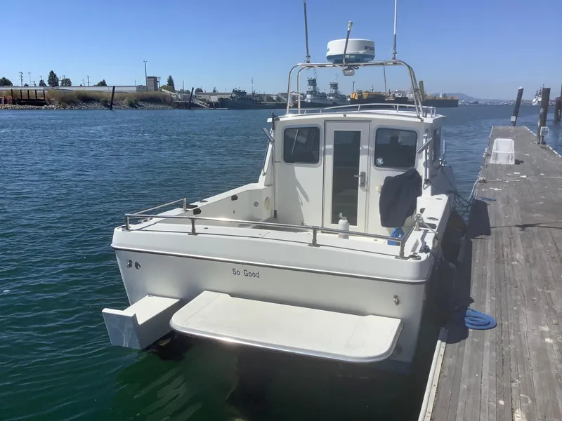 Slide: The Image of 2007 SeaSport Explorer 2400 docked at a marina, rear view. - 3