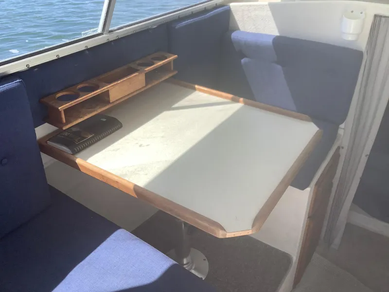Slide: The Image of Interior of 2007 SeaSport Explorer 2400 with table and blue seating. - 4