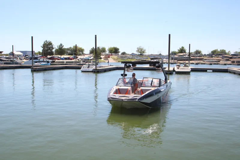 Slide: The Image of 2017 Tigé RZX3 boat docked in a marina on a sunny day. - 12