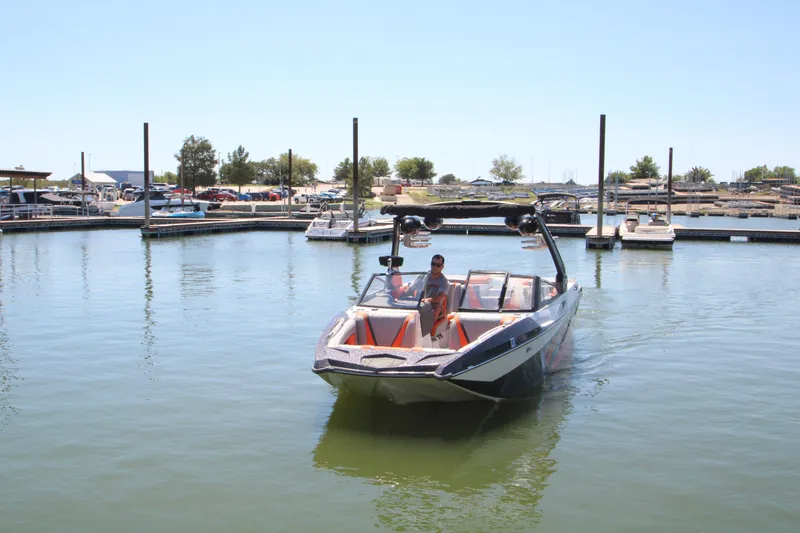 Slide: The Image of 2017 Tigé RZX3 boat in marina, calm water, clear sky. - 13