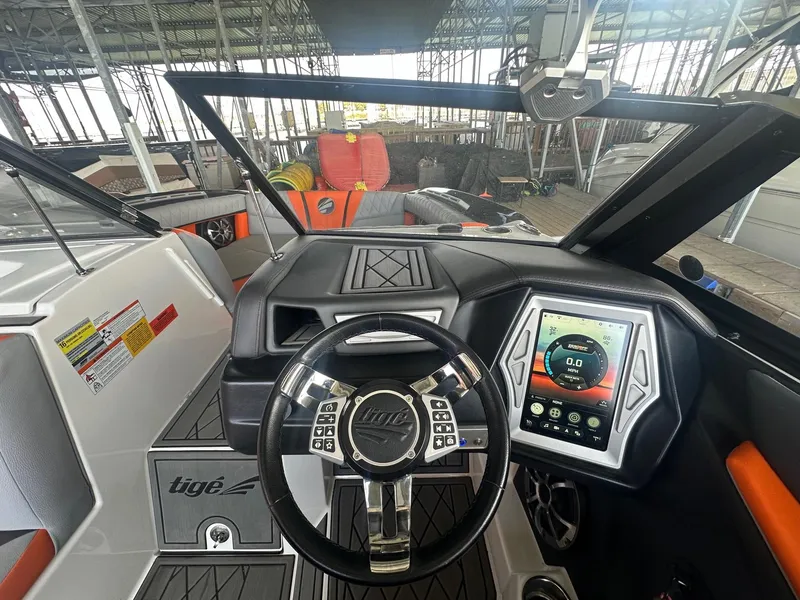 Slide: The Image of 2017 Tigé RZX3 boat dashboard with touchscreen controls and steering wheel. - 22