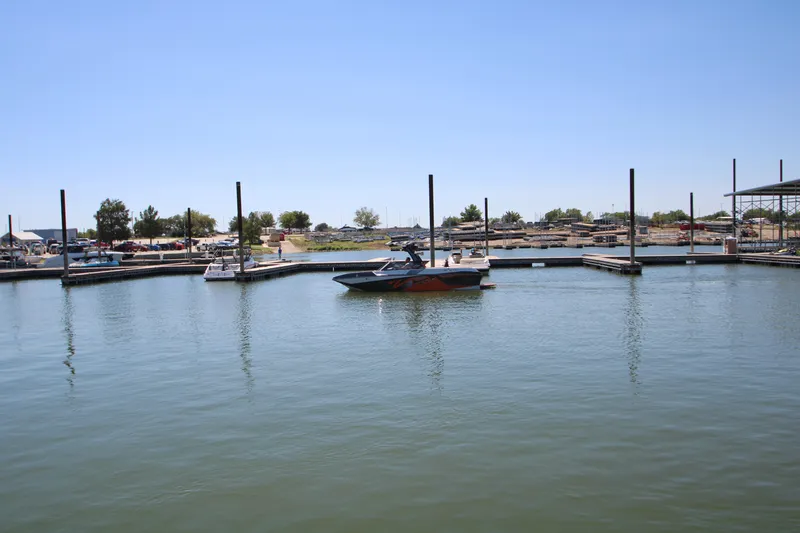Slide: The Image of 2017 Tigé RZX3 boat docked in a marina under clear blue skies. - 7