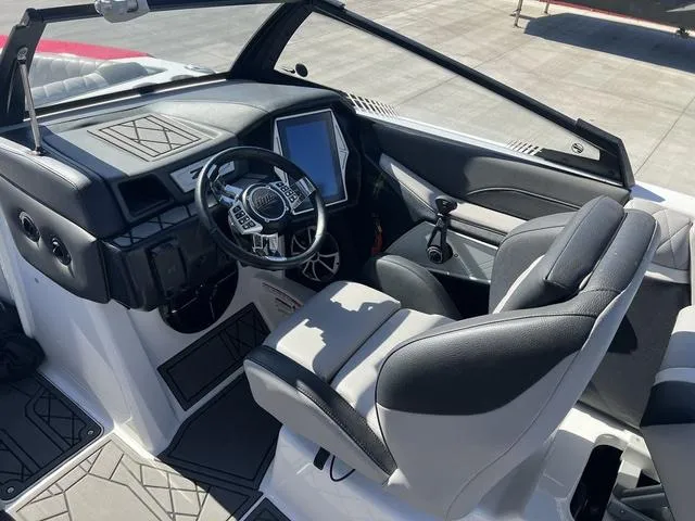 Slide: The Image of 2021 Tigé ZX Class 25 ZX boat interior with modern dashboard and steering wheel. - 13