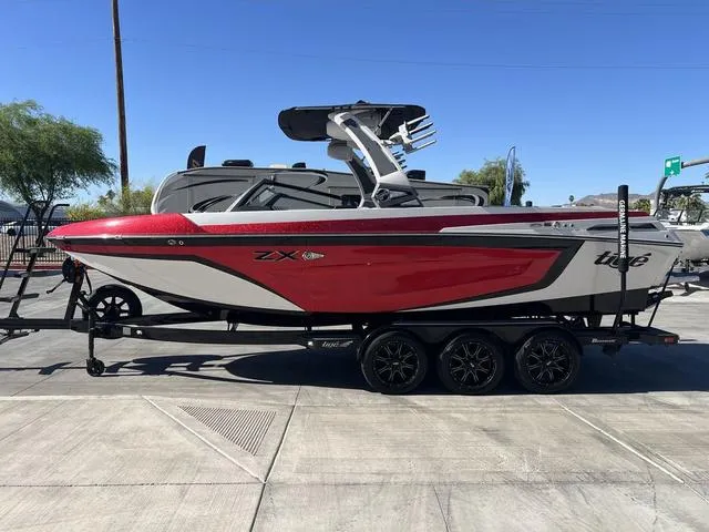 Slide: The Image of 2021 Tigé ZX Class 25 ZX boat in red and white on a trailer. - 5