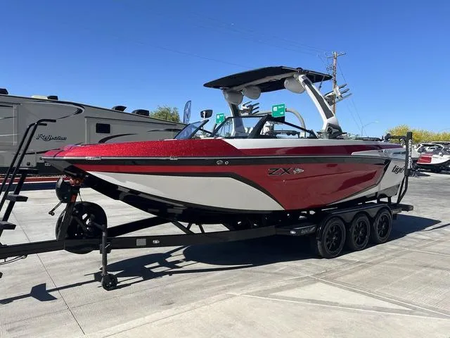 Slide: The Image of 2021 Tigé ZX Class 25 ZX boat on trailer, red and white design. - 6