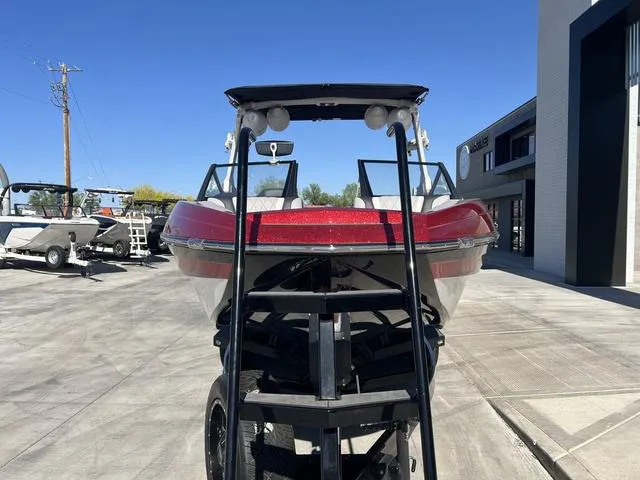 Slide: The Image of 2021 Tigé ZX Class 25 ZX boat on trailer, red and white, outdoor display. - 7