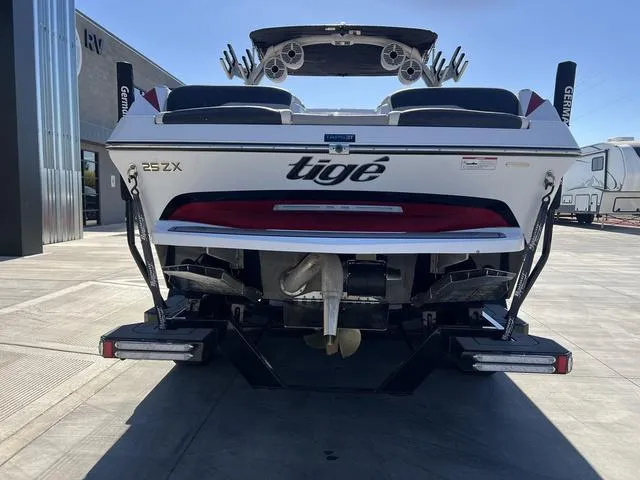 Slide: The Image of 2021 Tigé ZX Class 25 ZX boat rear view in a parking lot. - 9