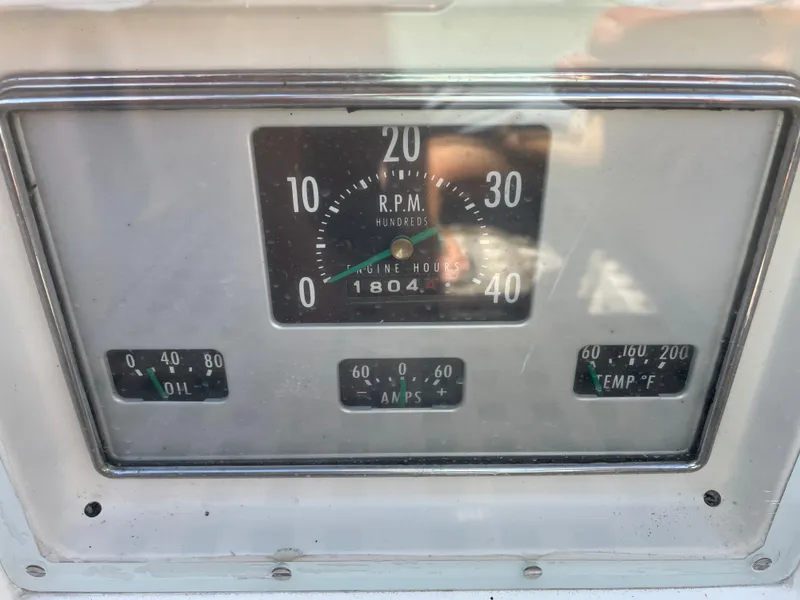 Slide: The Image of 1977 Hinckley Bermuda 40 MK III Sloop engine gauges displaying RPM, oil, amps, and temperature. - 12
