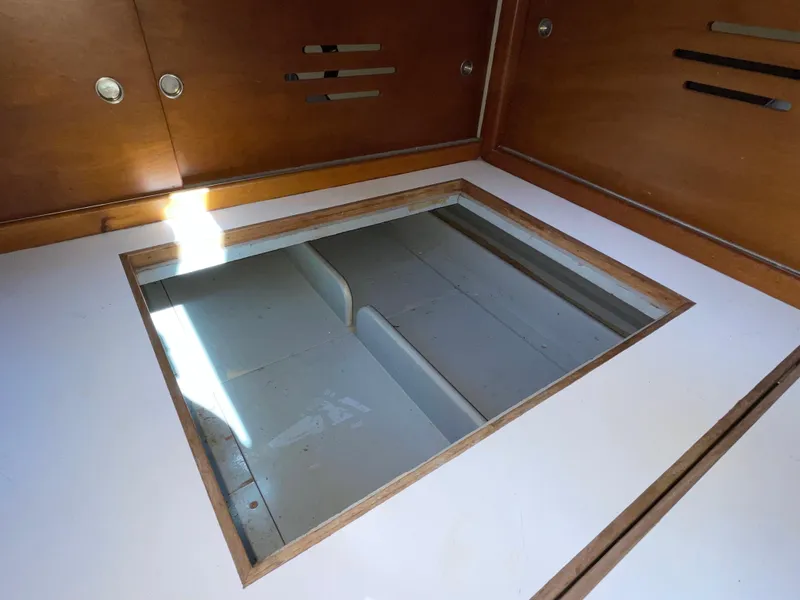 Slide: The Image of Hinckley Bermuda 40, MK III Sloop 1977 interior storage compartment with wooden finish. - 25