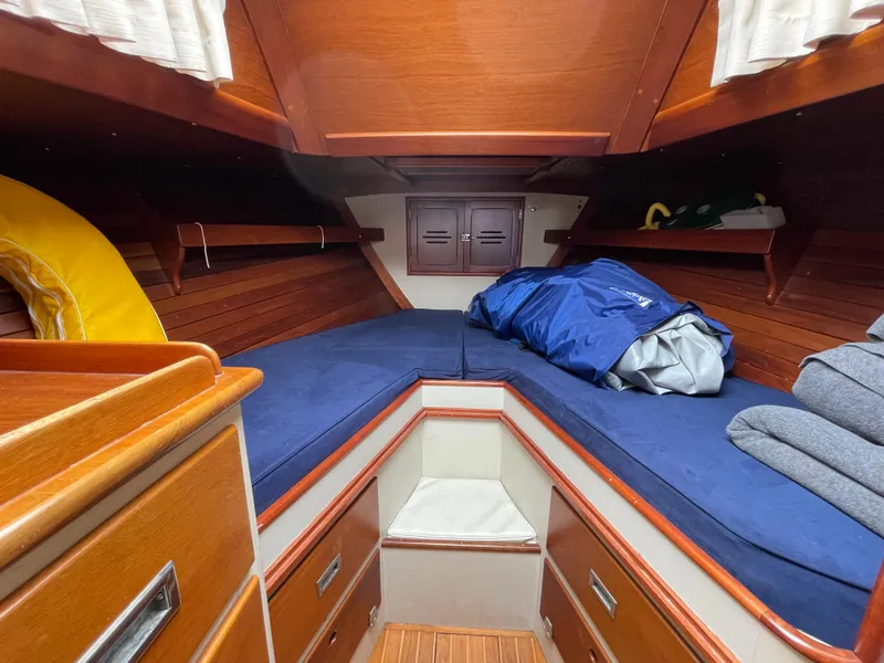Slide: The Image of 1977 Hinckley Bermuda 40 MK III Sloop cabin with blue cushions and wooden interior. - 39