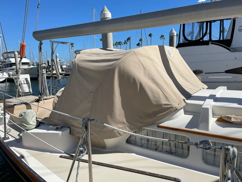 Slide: The Image of 1977 Hinckley Bermuda 40 MK III Sloop docked, covered with beige canvas. - 45