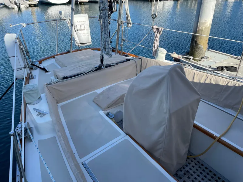 Slide: The Image of 1977 Hinckley Bermuda 40 MK III Sloop, docked with covered cockpit, in a marina setting. - 5