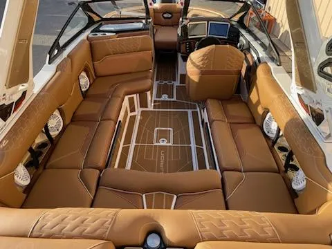 Slide: The Image of Luxurious interior of 2024 Centurion Ri230 boat with tan leather seating and modern dashboard. - 4