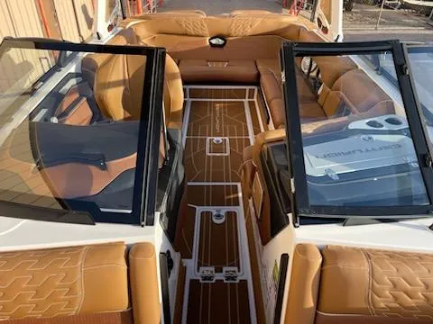 Slide: The Image of 2024 Centurion Ri230 boat interior with tan leather seats and sleek design. - 7