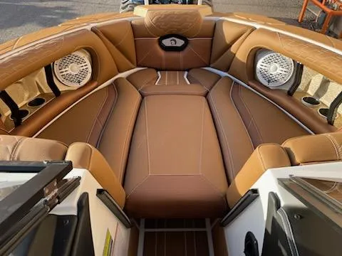Slide: The Image of 2024 Centurion Ri230 boat interior with brown leather seating and built-in speakers. - 8