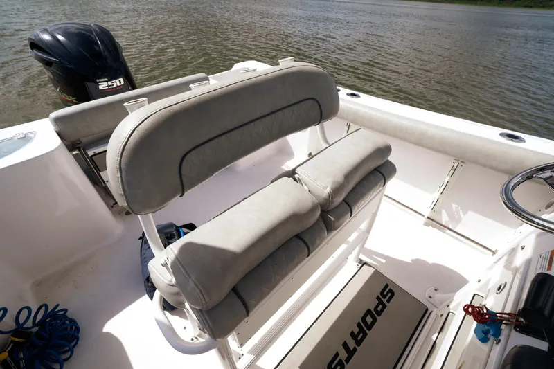Slide: The Image of 2020 Sportsman Open 232 Center Console boat interior with seating and outboard motor. - 4