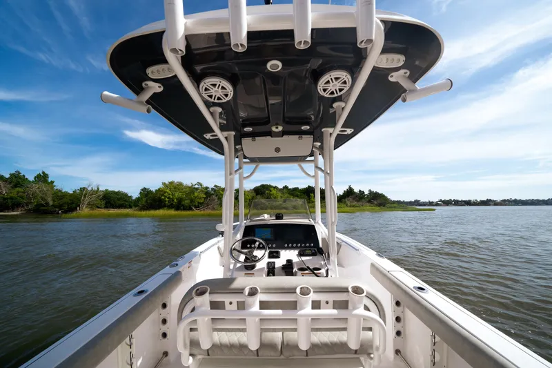 Slide: The Image of 2020 Sportsman Open 232 Center Console boat on calm water, clear sky background. - 5