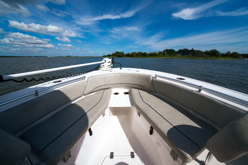 Slide: The Image of 2020 Sportsman Open 232 Center Console boat on a sunny day, featuring spacious seating. - 6