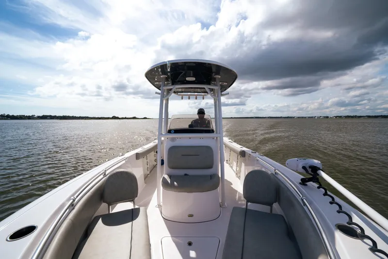 Slide: The Image of 2020 Sportsman Open 232 Center Console boat on calm water under cloudy sky. - 7