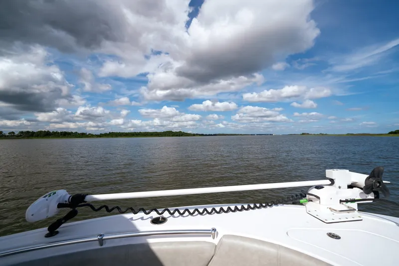 Slide: The Image of 2020 Sportsman Open 232 Center Console boat on calm water under a cloudy sky. - 8