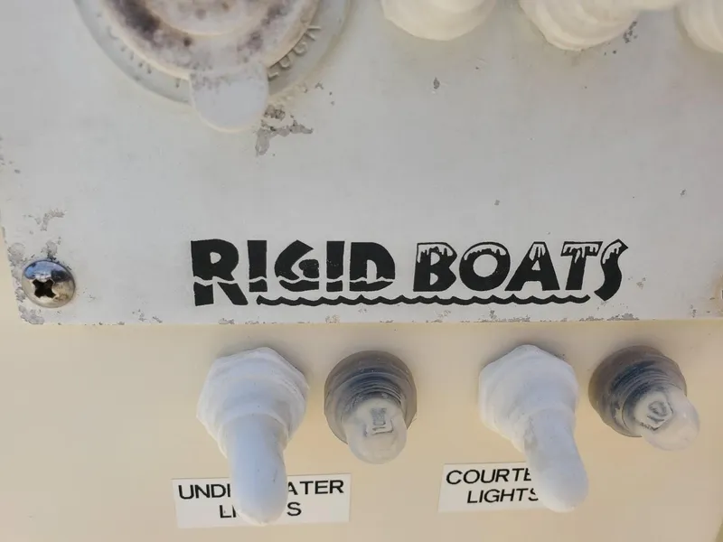 Slide: The Image of Control panel of 2013 Rigid Boats 12 Sport with light switches. - 15