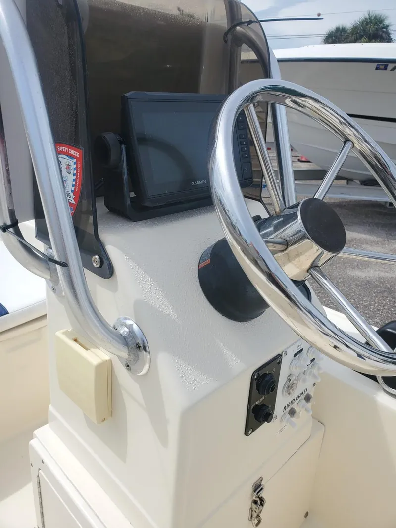 Slide: The Image of 2013 Rigid Boats 12 Sport console with steering wheel and navigation system. - 9