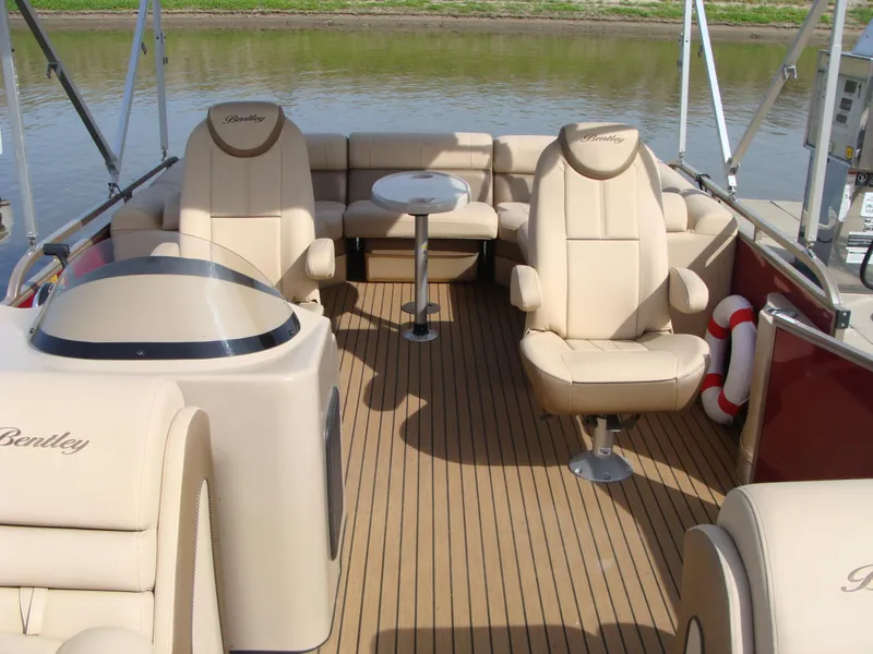 Slide: The Image of 2019 Bentley Pontoons 253 Admiral Elite interior with luxurious seating and wood flooring. - 4