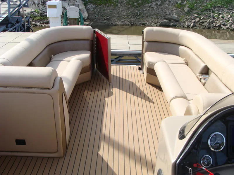 Slide: The Image of 2019 Bentley Pontoons 253 Admiral Elite interior with beige seating and wood-style flooring. - 6
