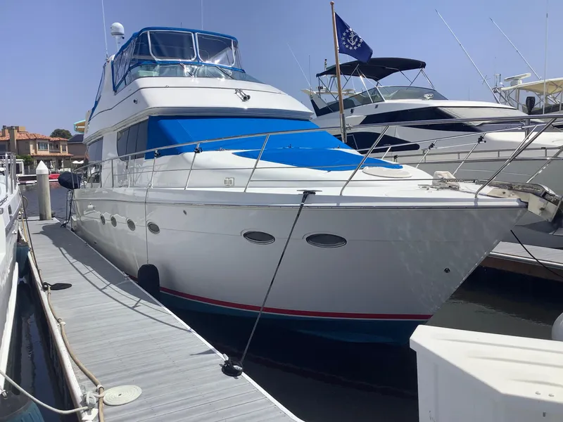 Slide: The Image of 1999 Carver 530 Voyager Pilothouse yacht docked at marina. - 1