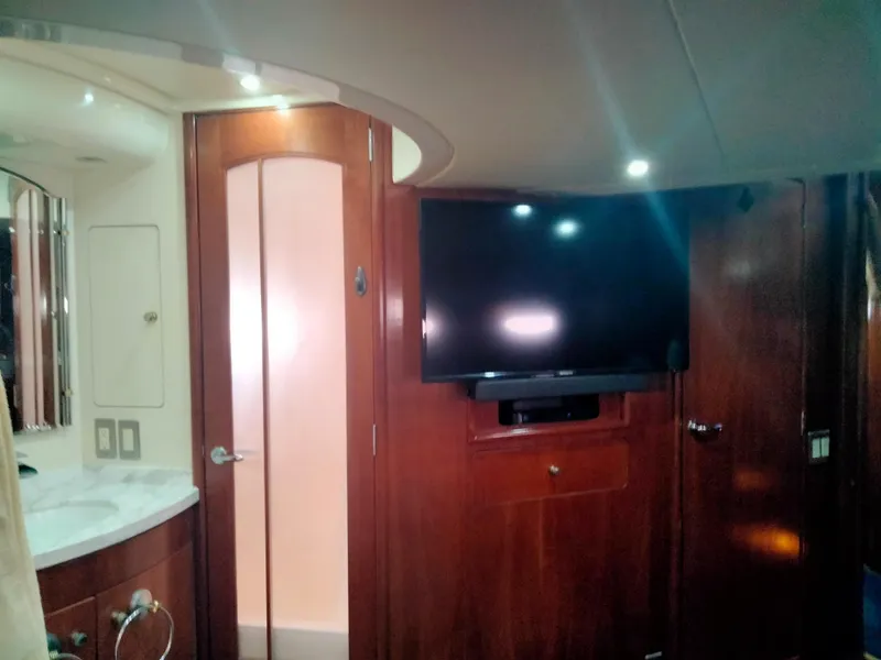 Slide: The Image of Interior of 1999 Carver 530 Voyager Pilothouse with TV and wood paneling. - 25