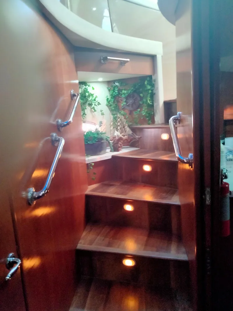 Slide: The Image of Interior of Carver 530 Voyager Pilothouse yacht, stairs with plants. - 23