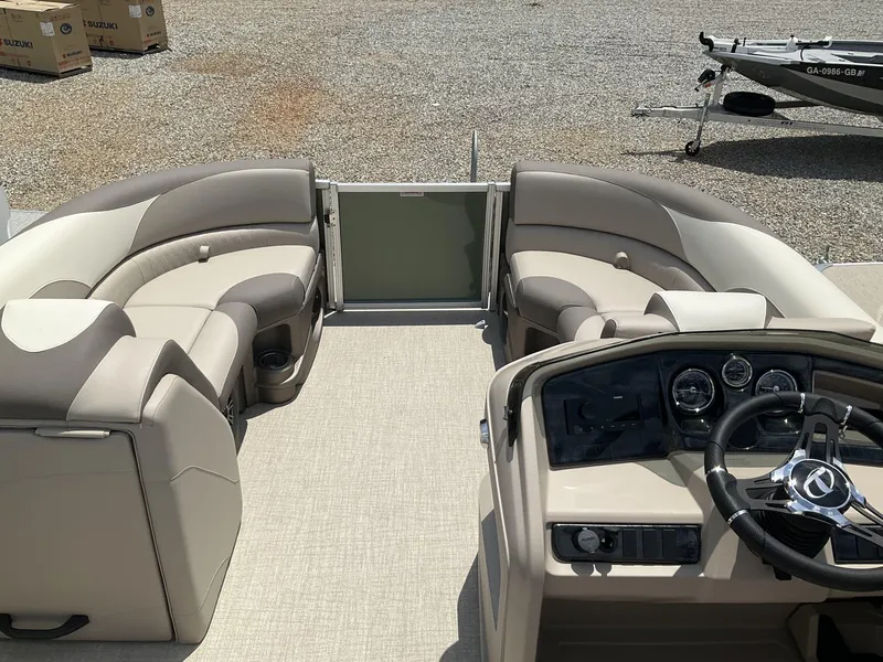 Slide: The Image of 2024 Tahoe Pontoon LTZ boat interior with versatile rear lounger and modern dashboard. - 11