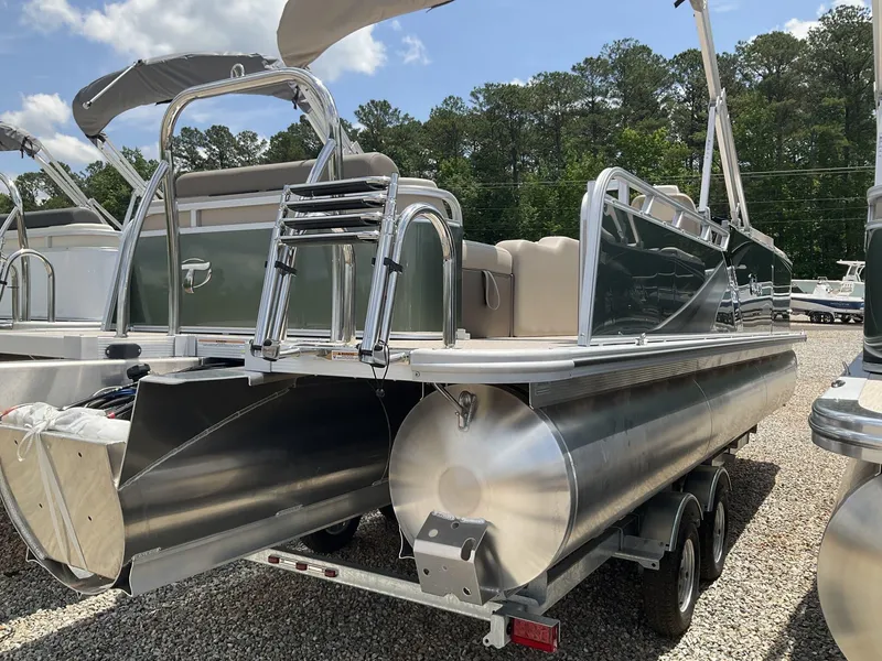 Slide: The Image of 2024 Tahoe Pontoon LTZ 23 FT Versatile Rear Lounger, parked on gravel lot. - 3