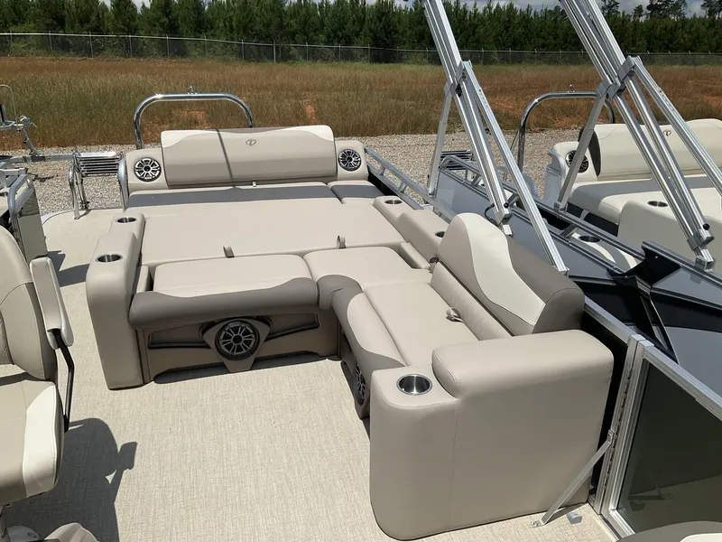 Slide: The Image of 2024 Tahoe Pontoon LTZ boat with versatile rear lounger, beige seating, and cup holders. - 7