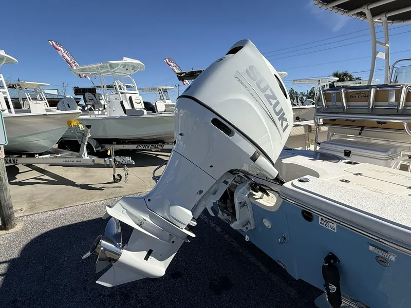 Slide: The Image of 2023 Sea Chaser Bay Runner Series 21 LX with Suzuki outboard motor in a marina. - 3