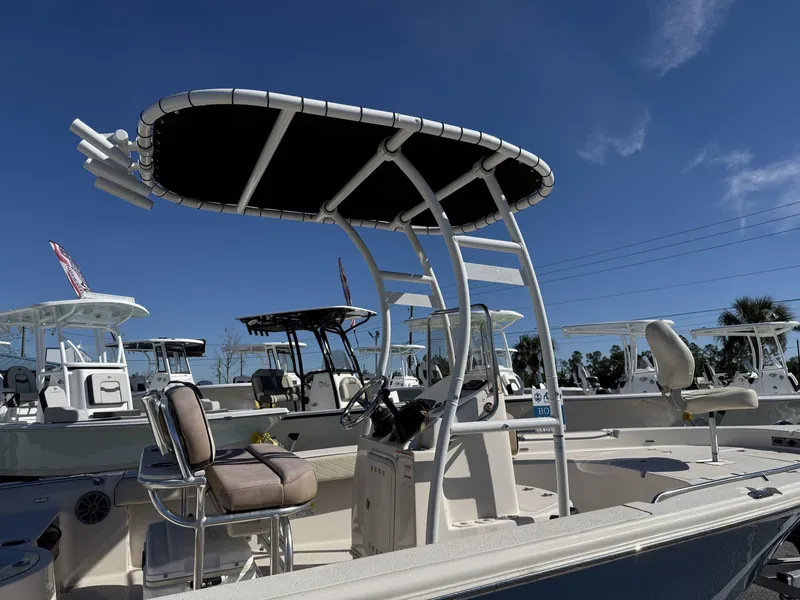 Slide: The Image of 2023 Sea Chaser Bay Runner Series 21 LX boat with T-top and seating, under clear blue sky. - 6