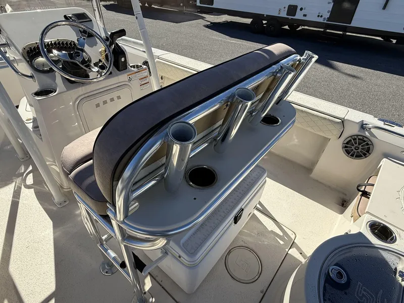 Slide: The Image of 2023 Sea Chaser Bay Runner Series 21 LX boat interior with rod holders and steering console. - 8