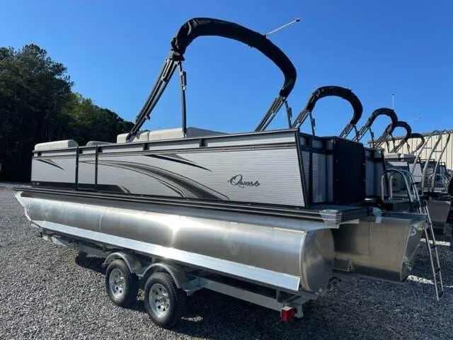 Slide: The Image of 2023 Qwest Pontoons E-Class XRE Cruise 822 LT on trailer, sleek design, sunny day. - 4