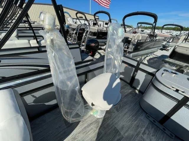 Slide: The Image of 2023 Qwest Pontoons E-Class XRE Cruise 822 LT interior with seating and protective covers. - 9