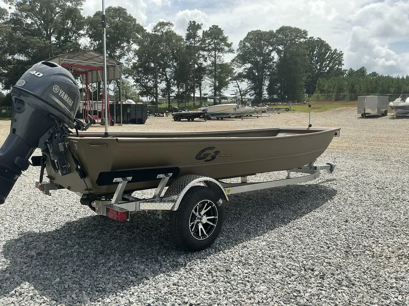 Slide: The Image of 2025 G3 Gator Tough 15 DK boat on trailer with Yamaha motor in outdoor setting. - 12