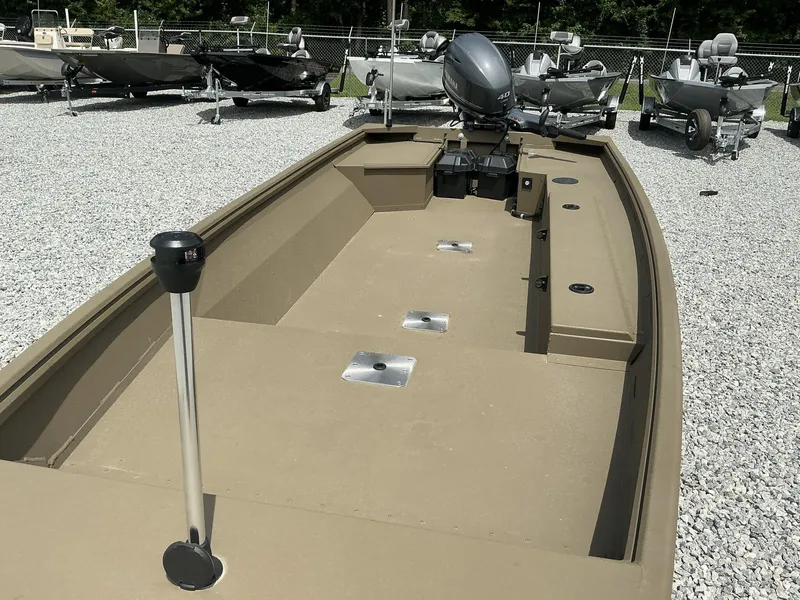 Slide: The Image of 2025 G3 Gator Tough 15 DK boat on gravel lot, featuring spacious interior and outboard motor. - 16