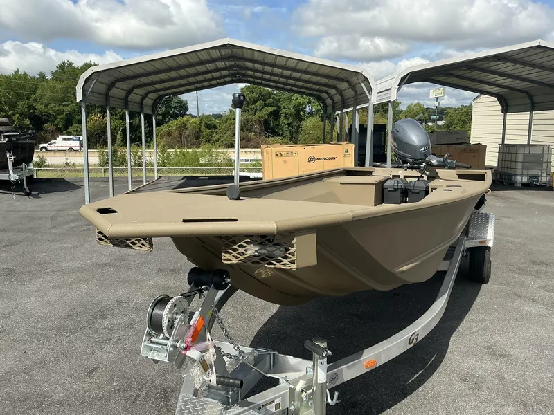 Slide: The Image of 2025 G3 Gator Tough 15 DK boat on trailer under metal canopy. - 4